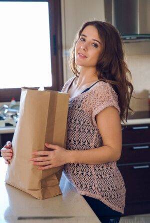 Petite brunette Sybil A poses her naked teen body on kitchen counter in socks on nudesceleb.com