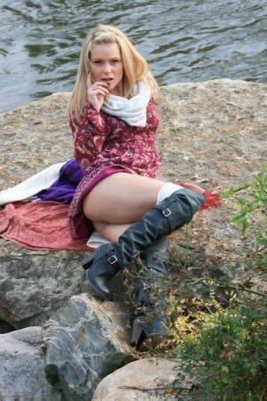 Slutty Madden in boots lifting her skirt outdoors to give a booty glimpse on nudesceleb.com