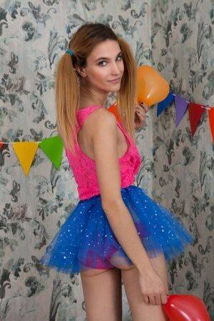 Tiny cutie Rosi shows her flat chest and tight slit in a tutu amid balloons on nudesceleb.com