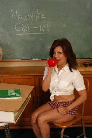 Older woman Melina dressed as a schoolgirl and masturbating shaved vagina on nudesceleb.com