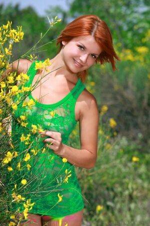 Beautiful redhead Violla A takes off short dress to get naked on a dirt path on nudesceleb.com