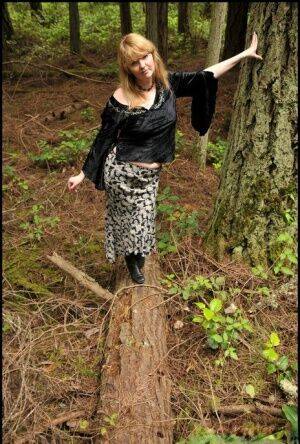 Mature lady Tasty Trixie hikes up her skirt for a quick piss in the woods on nudesceleb.com