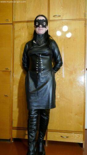 Collared solo woman models leather clothing while wearing a mask on nudesceleb.com