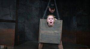 Blonde girl Odette Delacroix is made to suck a black cock with head in stocks on nudesceleb.com