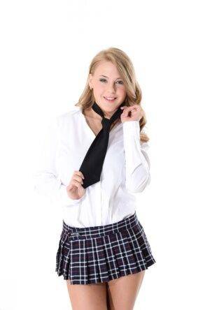 Cute blond Deny strips off a schoolgirl outfit before standing naked on nudesceleb.com