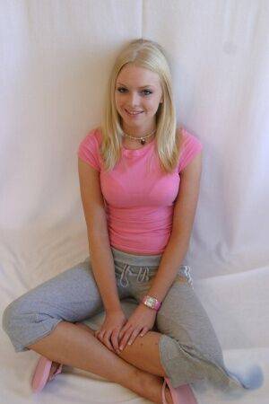 Cute teen girl Skye Model hangs out in a pink shirt and her yoga pants on nudesceleb.com