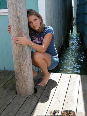 Cute young Karen squats on the pier to flash a hot cotton panty upskirt on nudesceleb.com