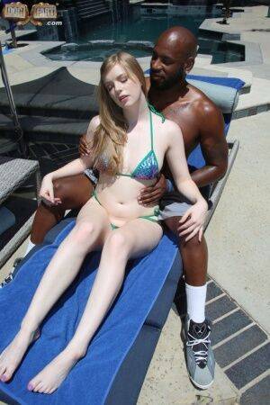 Sexy blonde gives a hot footjob to a black guy before having interracial sex on nudesceleb.com