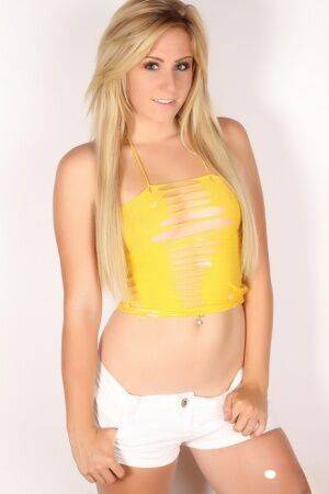 Blonde amateur Ashley Vallone models non nude in a revealing top and shorts on nudesceleb.com