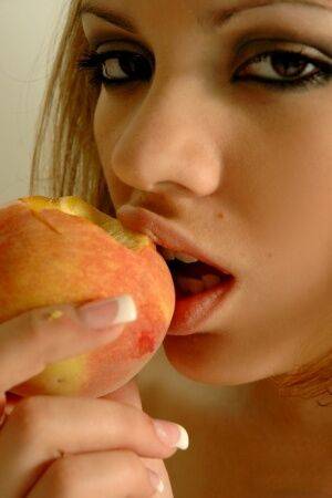 Teen first timer eats a peach with no panties on underneath her dress on nudesceleb.com