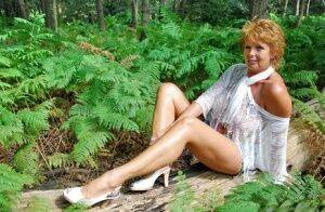 Mature redhead puts her great legs on display during a non-nude shoot on nudesceleb.com