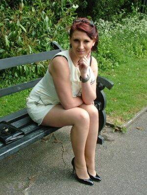 Thick woman in glasses shows off her stiletto heels on a park bench on nudesceleb.com