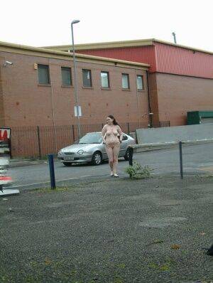 Plump girl goes for a naked walk in parking lot in industrial area on nudesceleb.com