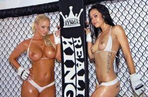 Busty lesbian babes stripping and posing in the wrestling cage on nudesceleb.com