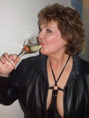 Mature amateur Busty Bliss sucks on her fingers while drinking too much wine on nudesceleb.com