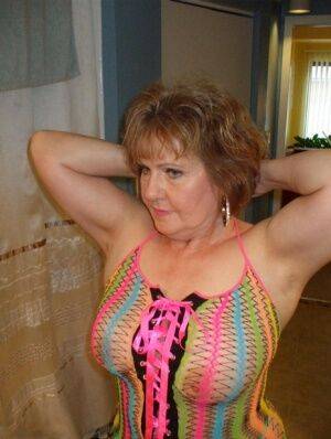 Mature wifey Busty Bliss posing in her exotic see through mesh top on nudesceleb.com