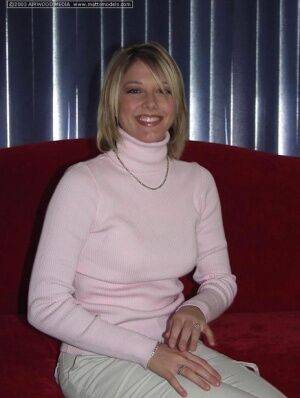 Blonde amateur Kyra frees her perky breasts from turtleneck sweater on nudesceleb.com