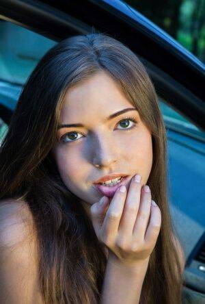 Beautiful teen girl models in the nude on passenger seat of car with door open on nudesceleb.com