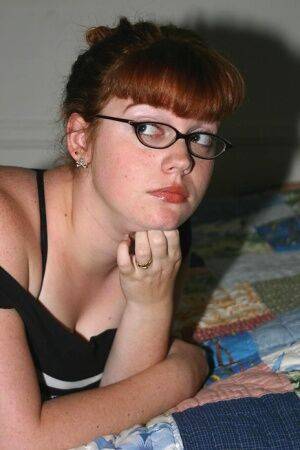 Chubby nerd with red hair takes off her glasses after uncupping big naturals on nudesceleb.com