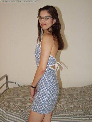 Geeky amateur Angelina removes her dress and glasses for her first nude poses on nudesceleb.com