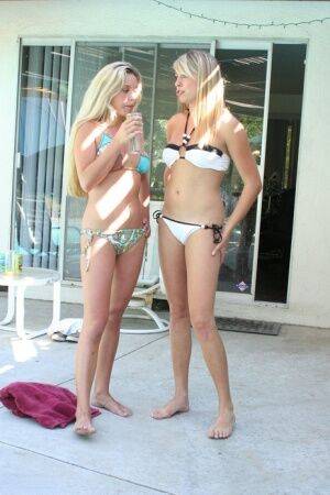 Blonde lesbians take up their bikinis to go naked in a swimming pool on nudesceleb.com