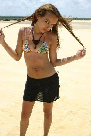 Latina teen Miranda Mirelli models in a bikini atop a sand dune on nudesceleb.com