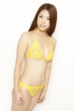 Young Japanese redhead models a yellow bikini in a safe for shoot - Japan on nudesceleb.com