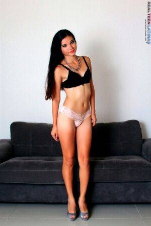 Latina teen Denisse models by herself in a bra and thong plus high heels on nudesceleb.com