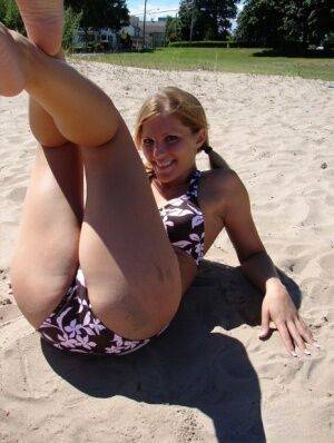 Blonde amateur Karen models her new bikini on a volleyball pitch on nudesceleb.com