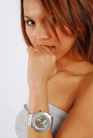 Sexy redhead Mocca models a Swatch Irony The Chrono watch in a clingy dress on nudesceleb.com