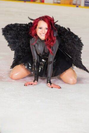 Redhead amateur Lara Larsen models non nude in latex attire with wings on nudesceleb.com