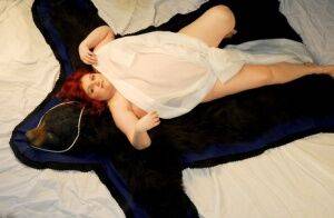 Fat redhead Black Widow AK models totally naked on a bearskin rug on nudesceleb.com