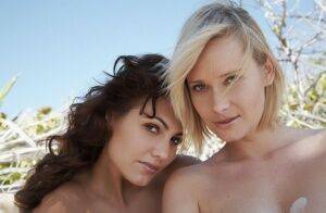 Glamour models Deni & Gabriela get atop each other while posing nude on sand on nudesceleb.com