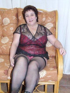 Mature BBW Kinky Carol models sexy lingerie in mesh stockings and heels on nudesceleb.com