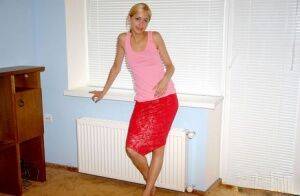 Young blonde girl models non nude in a knee length skirt and tank top on nudesceleb.com