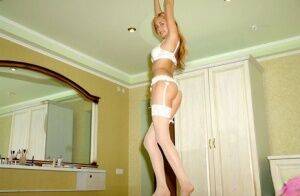 Solo girl with long hair models non nude in white lingerie and stockings on nudesceleb.com