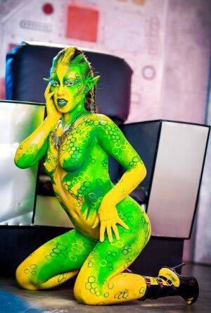 Kinky cosplay chick Tiffany Doll posing in body paint uniform and spreading on nudesceleb.com