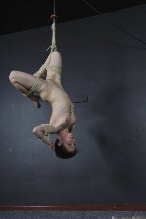 Tattooed female is bound with roped and suspended from the ceiling on nudesceleb.com