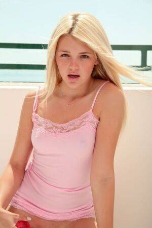 Sweet blonde girl Holly Van Hough gets naked and pleasures herself on balcony on nudesceleb.com