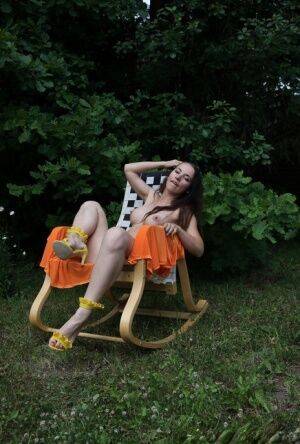 Barely legal brunette Nicole V gets naked on a backyard rocking chair on nudesceleb.com