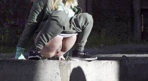 Caucasian girl Diana pisses on a sidewalk in a derelict environment on nudesceleb.com