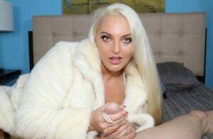 Platinum blonde chick Macy Cartel tugs on a dick while draped in a fur coat on nudesceleb.com
