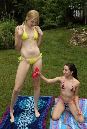 Short and tall lesbians remove bikinis before scissoring and fisting in yard on nudesceleb.com