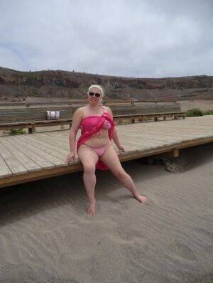 Older platinum blonde Barby exposes her plump body at the seaside on nudesceleb.com