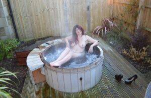 Amateur lady Barby Slut gets totally nude before getting in an outdoor hot tub on nudesceleb.com