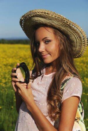 Country girl Mango A loses her shorts to crawl around nude in the sunny field on nudesceleb.com