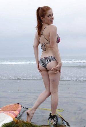 Ginger girl with large ass Penny is showing her skills on the beach on nudesceleb.com