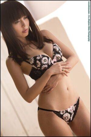 Beautiful Asian model Marica Hase strikes great poses while removing lingerie on nudesceleb.com