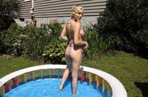 Blonde amateur Skye Blue dildos her pussy while in a backyard setting on nudesceleb.com