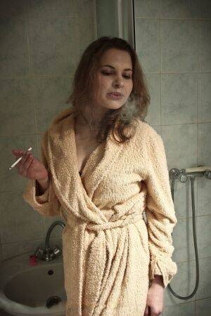 Solo model Vlada H smokes while fingering her pussy on bathroom floor on nudesceleb.com